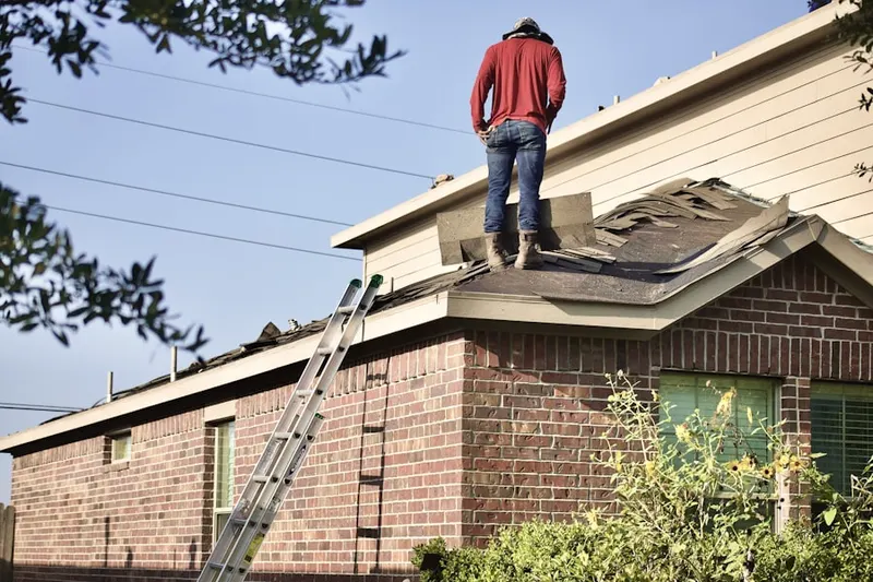 Professional roofer working on a residential roof in Robertsville
